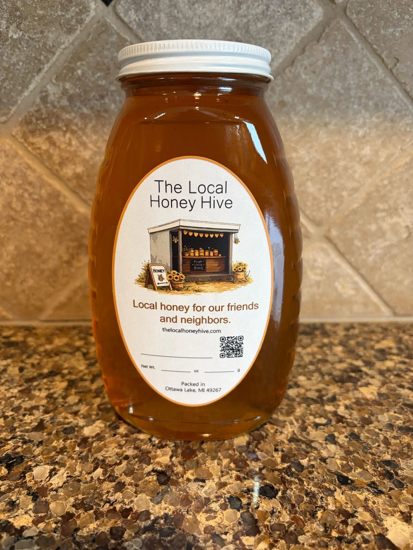 Golden honey in a Local Honey Hive jar, packed in Ottawa Lake, Michigan