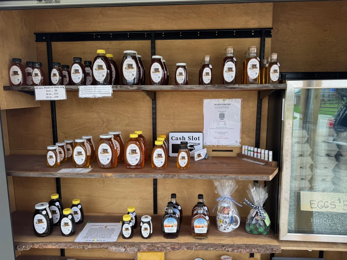 The honey stand shelves with local honey, gift sets, and seasonal products